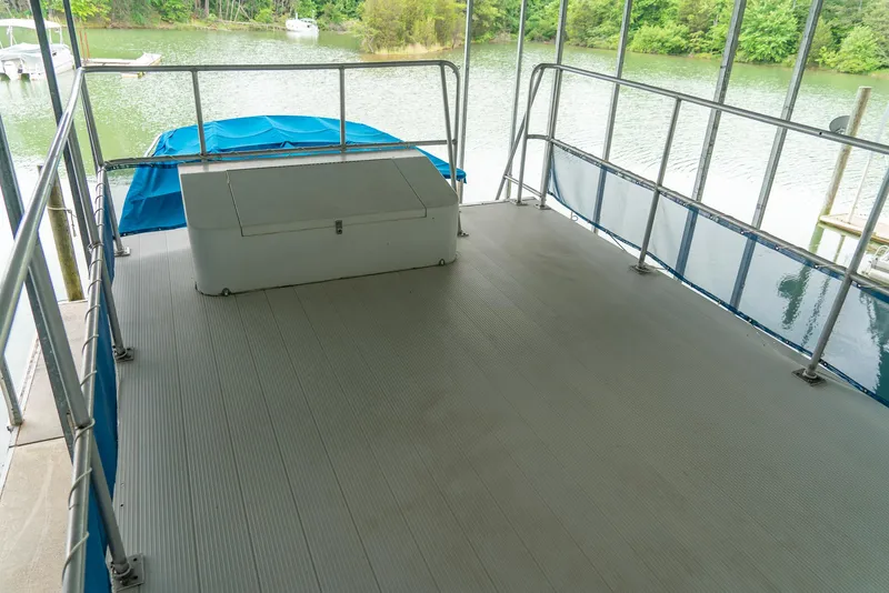 Slide: The Image of Spacious deck of a 2004 Custom 40' Navy Boat with railing and storage box. - 15