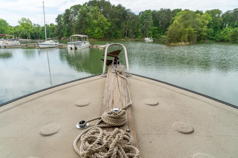Slide: The Image of Bow of a 2004 Custom 40' Navy Boat docked in a serene marina. - 16