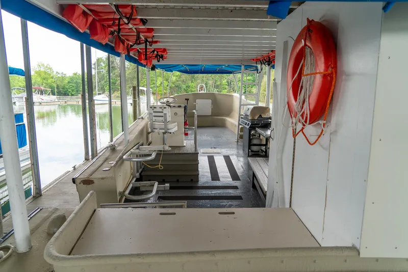 Slide: The Image of Interior of a 2004 Custom 40' Navy Boat with life jackets and a life preserver. - 3