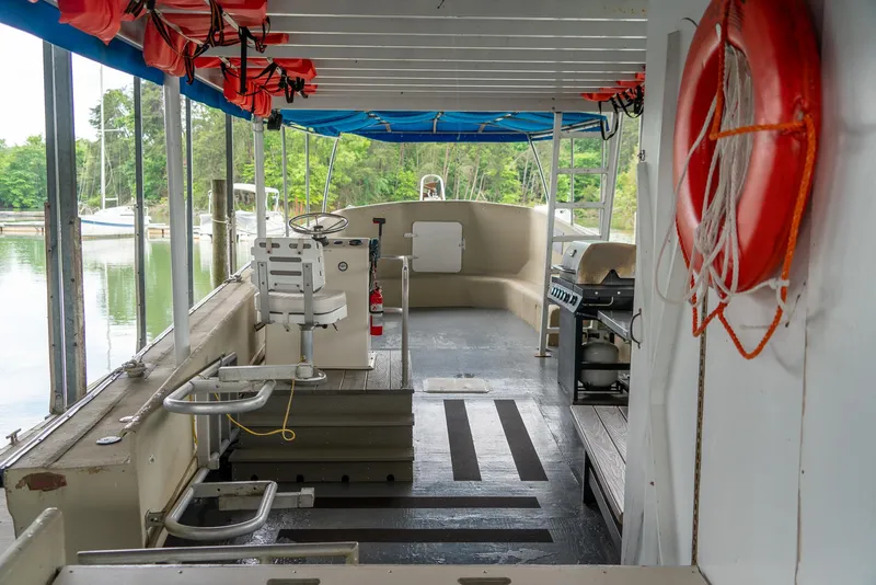 Slide: The Image of Interior of a 2004 Custom 40' Navy Boat with life jackets and safety equipment. - 4