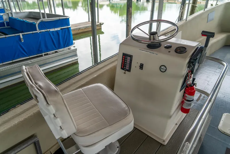 Slide: The Image of 2004 Custom 40' Navy Boat helm station with captain's chair and control panel. - 6