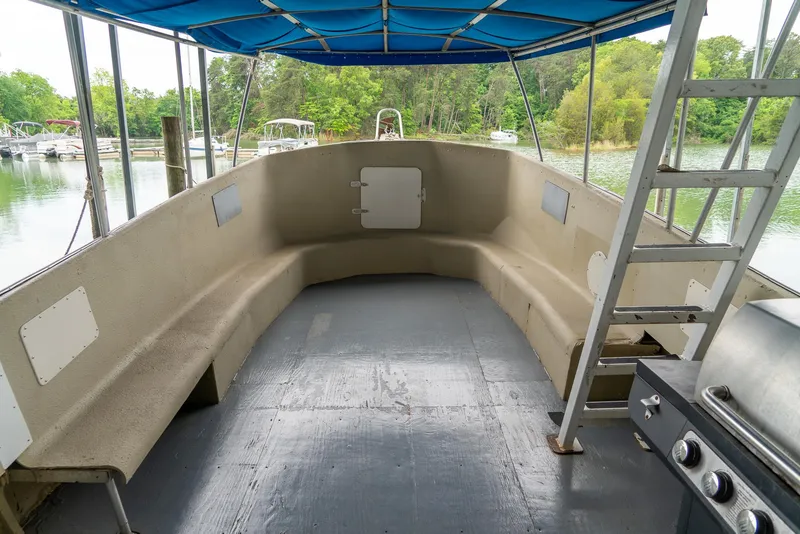 Slide: The Image of Interior of a 2004 Custom 40' Navy Boat with seating and a covered deck. - 8