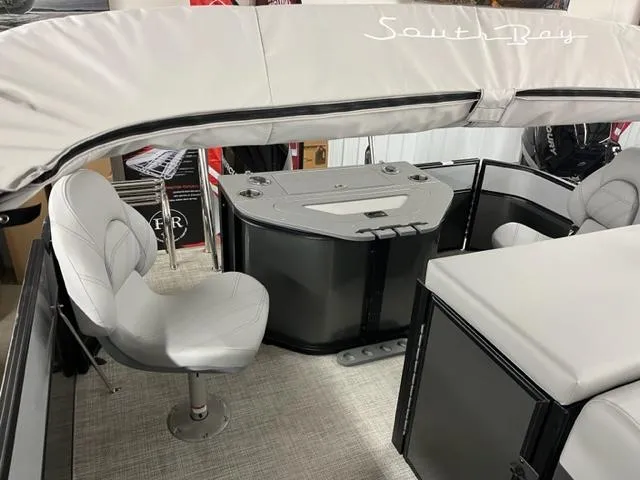 Slide: The Image of 2024 South Bay S222FCR3 pontoon boat interior with helm and seating. - 2