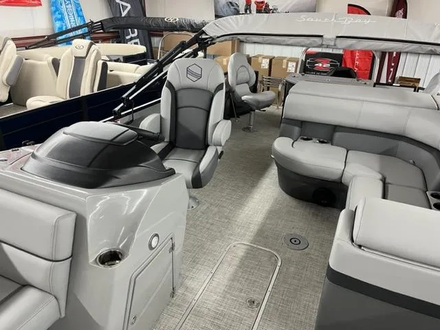 Slide: The Image of 2024 South Bay S222FCR3 pontoon boat interior with gray seating and helm station. - 4