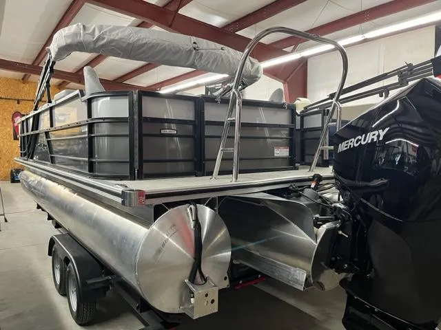 Slide: The Image of 2024 South Bay S222FCR3 pontoon boat with Mercury engine in a warehouse. - 6