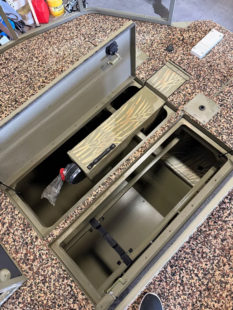 Slide: The Image of 2023 Tracker Grizzly 2072 CC Sportsman boat storage compartments, open and empty. - 13