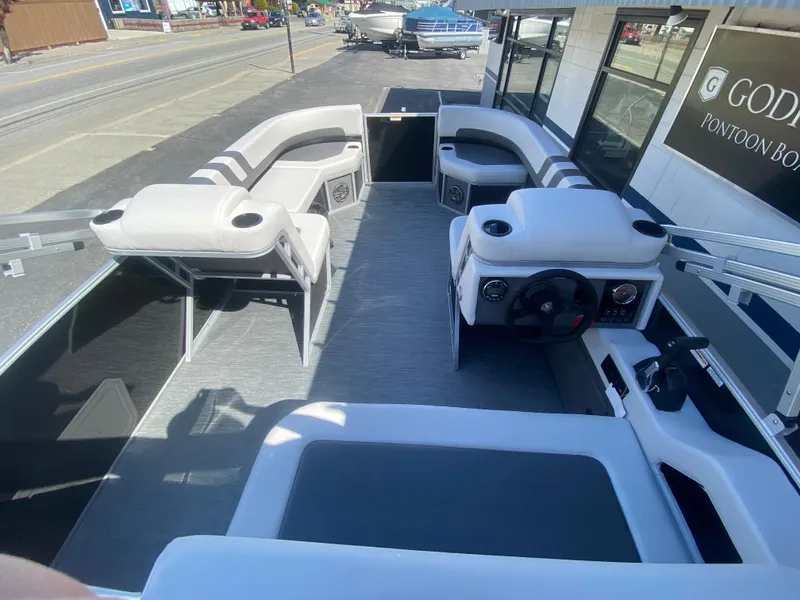 Slide: The Image of 2023 Godfrey MIGHTY G 1476C pontoon boat interior with seating and steering console. - 3