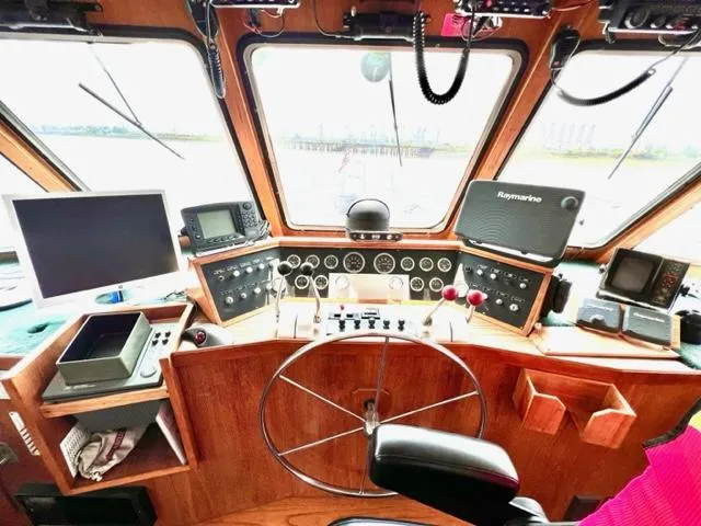 Slide: The Image of 1978 Jones-Goodell Pilothouse interior with navigation equipment and steering wheel. - 10