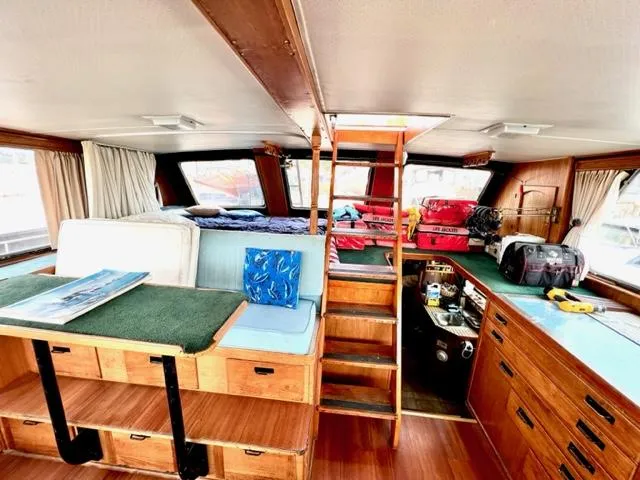 Slide: The Image of 1978 Jones-Goodell Pilothouse interior with wooden cabinetry and ladder. - 11