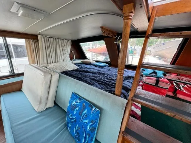 Slide: The Image of Interior of a 1978 Jones-Goodell Pilothouse boat with bed and seating area. - 12