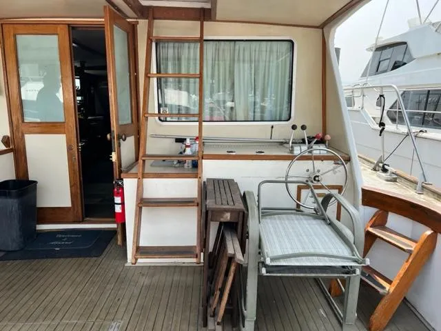 Slide: The Image of 1978 Jones-Goodell Pilothouse boat interior with wooden ladder and steering wheel. - 15