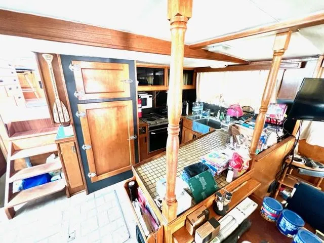 Slide: The Image of 1978 Jones-Goodell Pilothouse interior with wooden cabinetry and kitchen area. - 17