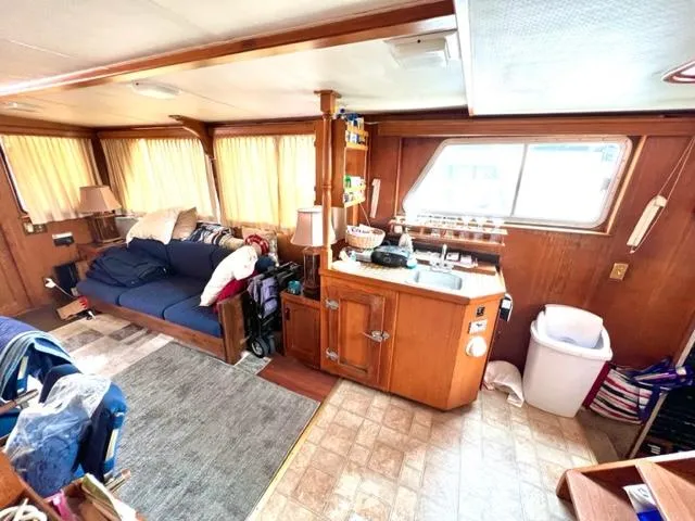 Slide: The Image of 1978 Jones-Goodell Pilothouse interior with cozy seating and kitchenette. - 18