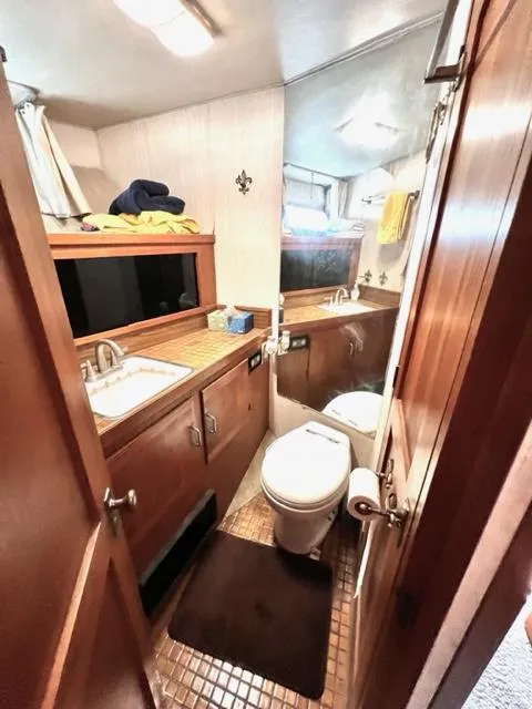 Slide: The Image of 1978 Jones-Goodell Pilothouse bathroom with wooden cabinets and modern fixtures. - 23