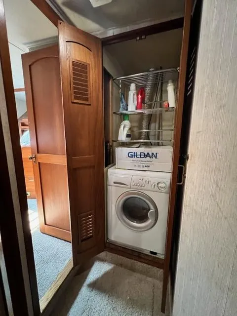 Slide: The Image of Laundry area in 1978 Jones-Goodell Pilothouse with washer and storage shelves. - 24