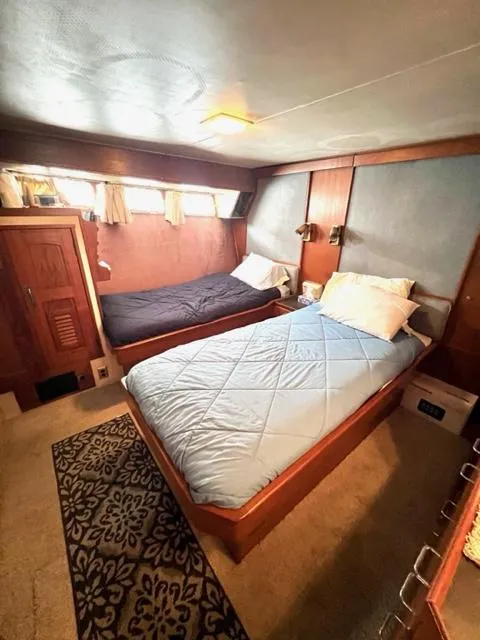 Slide: The Image of 1978 Jones-Goodell Pilothouse cabin with twin beds and wooden interior. - 26