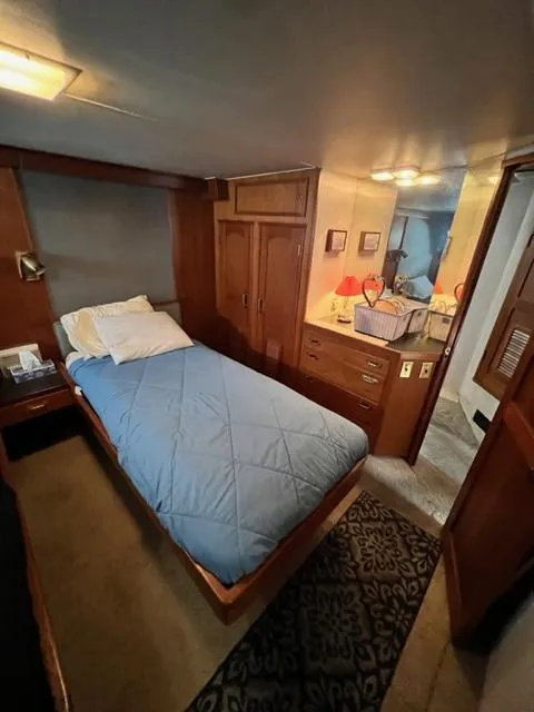 Slide: The Image of 1978 Jones-Goodell Pilothouse bedroom with single bed and wooden cabinetry. - 27
