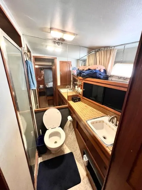 Slide: The Image of 1978 Jones-Goodell Pilothouse bathroom with shower, sink, and toilet. - 28