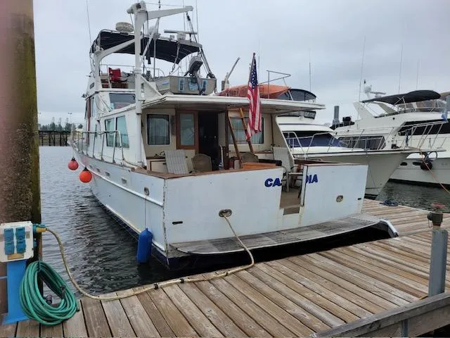 Slide: The Image of 1978 Jones-Goodell Pilothouse yacht docked at marina with American flag. - 3