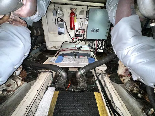Slide: The Image of Engine room of a 1978 Jones-Goodell Pilothouse boat with visible machinery and wiring. - 31