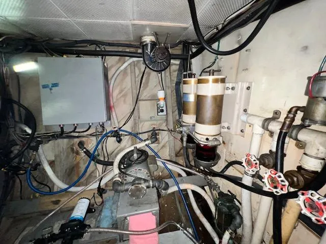 Slide: The Image of Engine room of a 1978 Jones-Goodell Pilothouse boat with various mechanical components. - 32