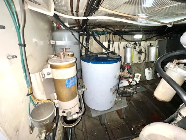 Slide: The Image of 1978 Jones-Goodell Pilothouse engine room with various mechanical components and wiring. - 33