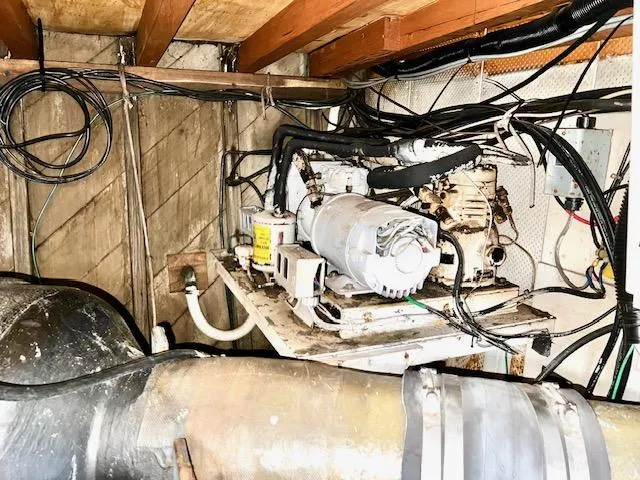 Slide: The Image of 1978 Jones-Goodell Pilothouse engine room with mechanical equipment and wiring. - 35