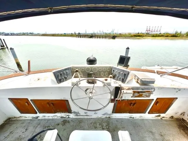 Slide: The Image of 1978 Jones-Goodell Pilothouse boat helm with steering wheel and control panel. - 5