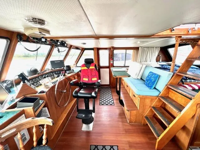 Slide: The Image of 1978 Jones-Goodell Pilothouse interior with helm, seating, and wooden accents. - 8