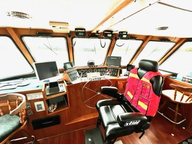 Slide: The Image of 1978 Jones-Goodell Pilothouse interior with navigation equipment and captain's chair. - 9