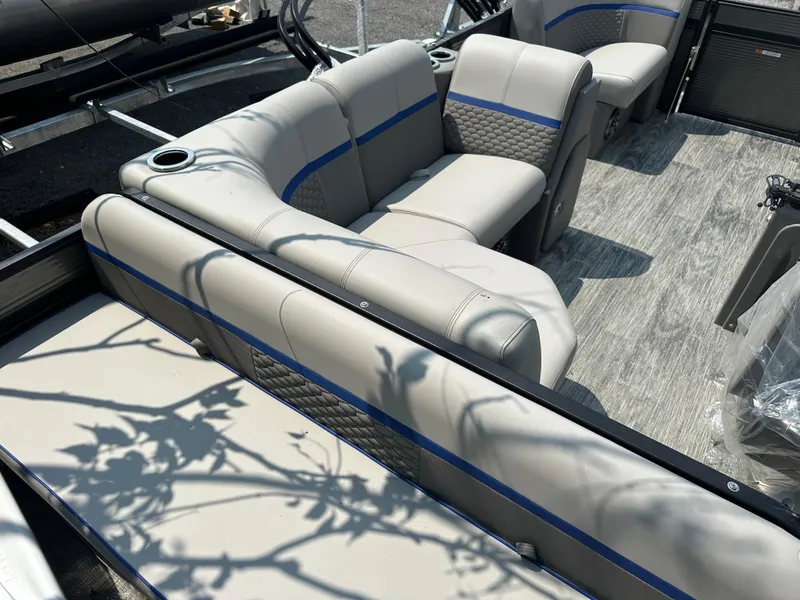 Slide: The Image of 2023 Qwest 816 Lanai LT boat interior with beige seating and blue accents. - 4