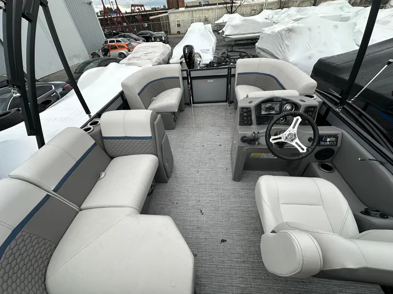 Slide: The Image of 2023 Qwest 816 Lanai LT pontoon boat interior with plush seating and modern dashboard. - 1