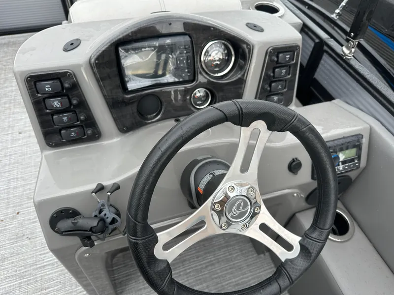 Slide: The Image of Steering console of 2023 Qwest 816 Lanai LT boat with modern controls and dashboard. - 3