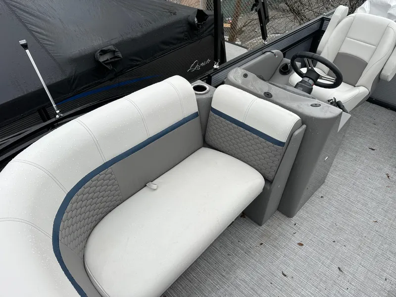 Slide: The Image of 2023 Qwest 816 Lanai LT boat interior with plush seating and steering console. - 4