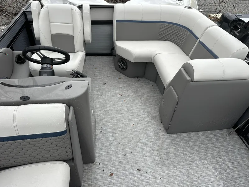 Slide: The Image of 2023 Qwest 816 Lanai LT boat interior with gray seating and steering wheel. - 9