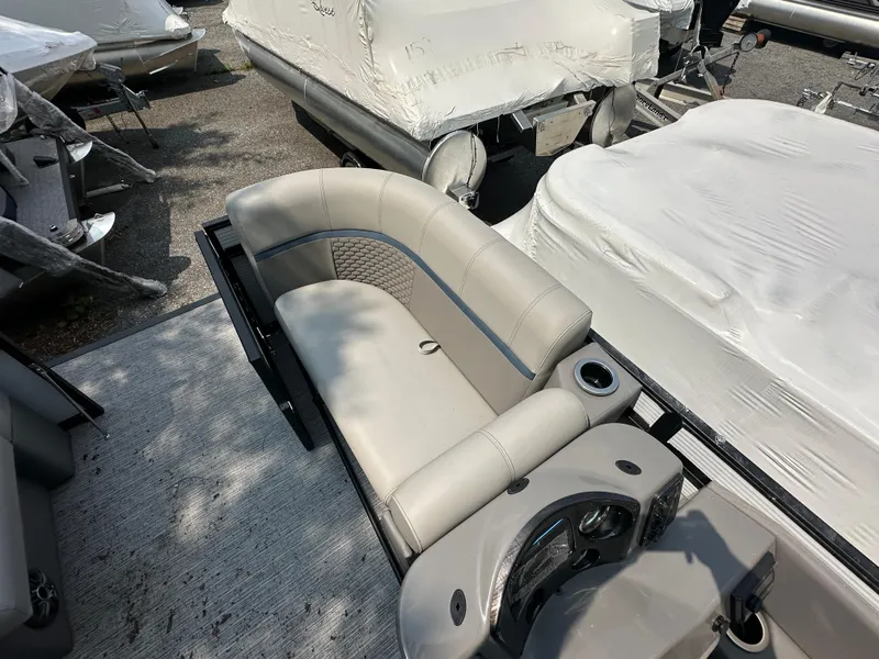 Slide: The Image of 2023 Qwest E 816 Lanai LT boat interior with beige seating and cup holders. - 9