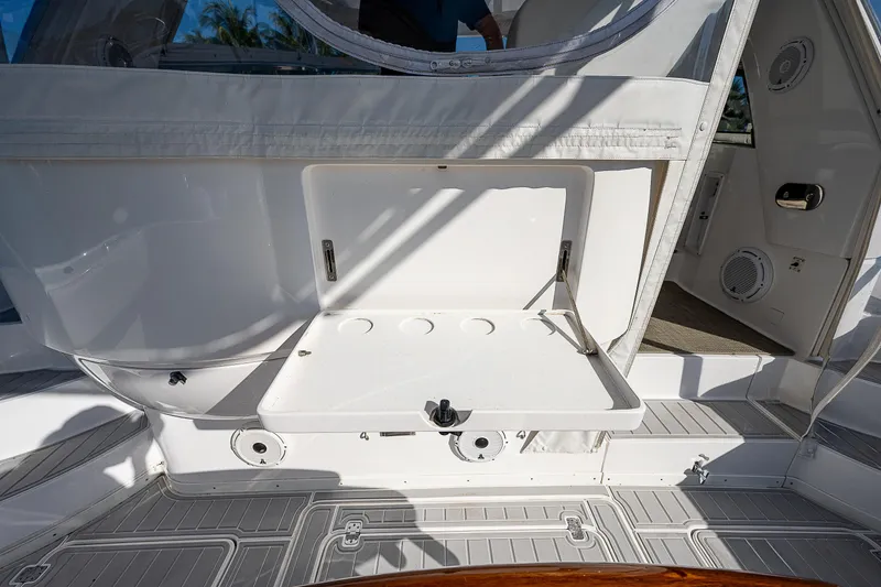 Slide: The Image of 2014 Intrepid 475 Sport Yacht interior with open storage compartment and sleek design. - 11