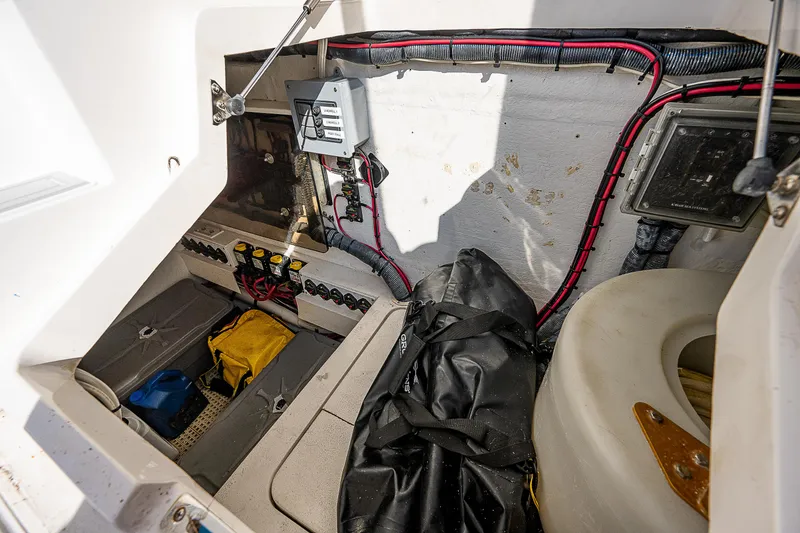 Slide: The Image of 2014 Intrepid 475 Sport Yacht storage compartment with wiring and equipment. - 13