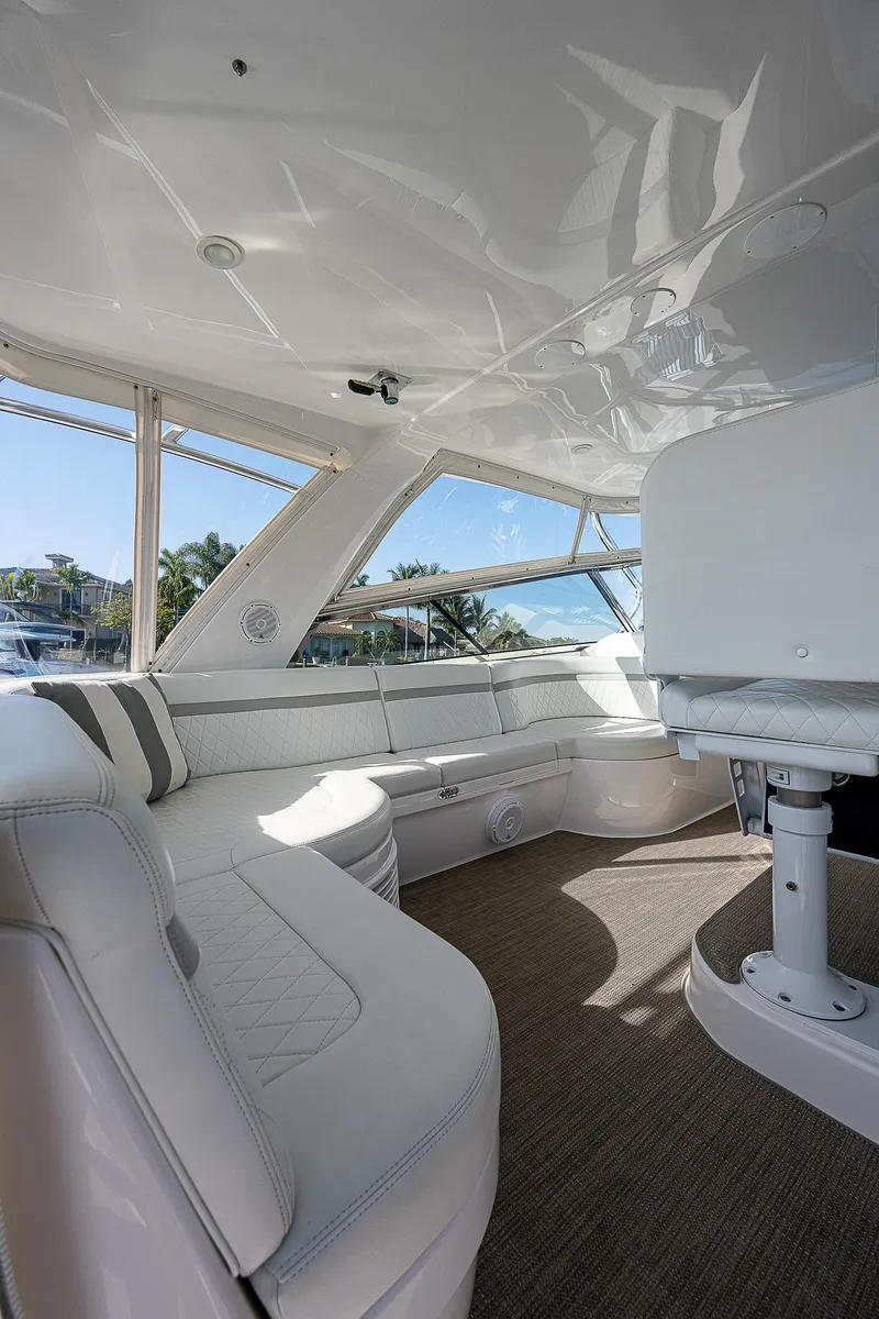 Slide: The Image of Luxurious interior of 2014 Intrepid 475 Sport Yacht with white seating and panoramic windows. - 14