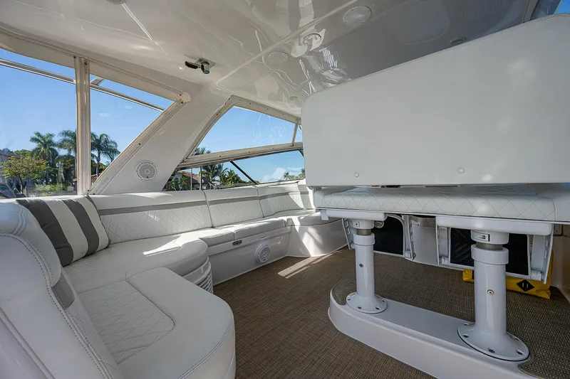 Slide: The Image of Interior of 2014 Intrepid 475 Sport Yacht with white seating and large windows. - 15
