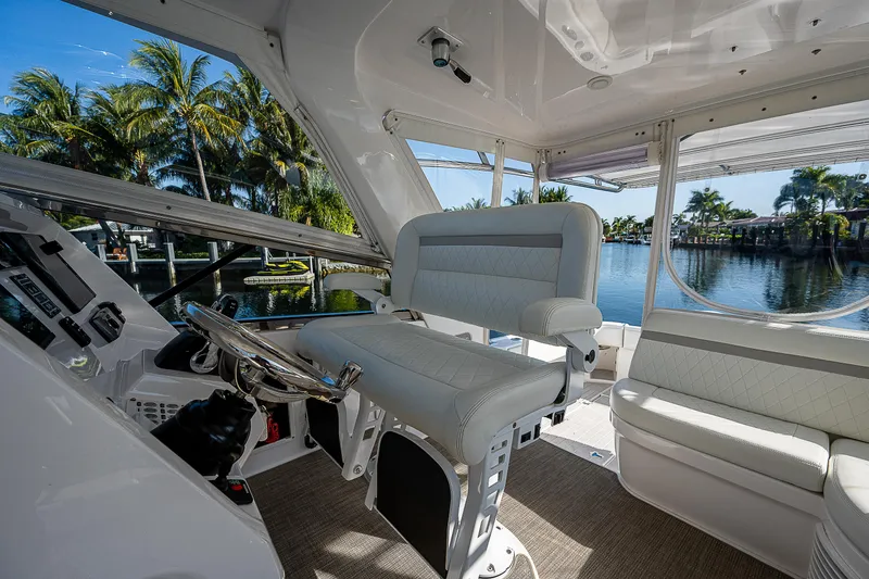 Slide: The Image of Interior of 2014 Intrepid 475 Sport Yacht with luxurious seating and scenic water view. - 18