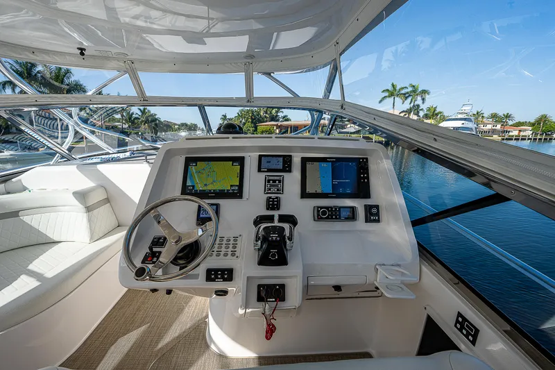 Slide: The Image of 2014 Intrepid 475 Sport Yacht helm with navigation screens and steering wheel. - 19