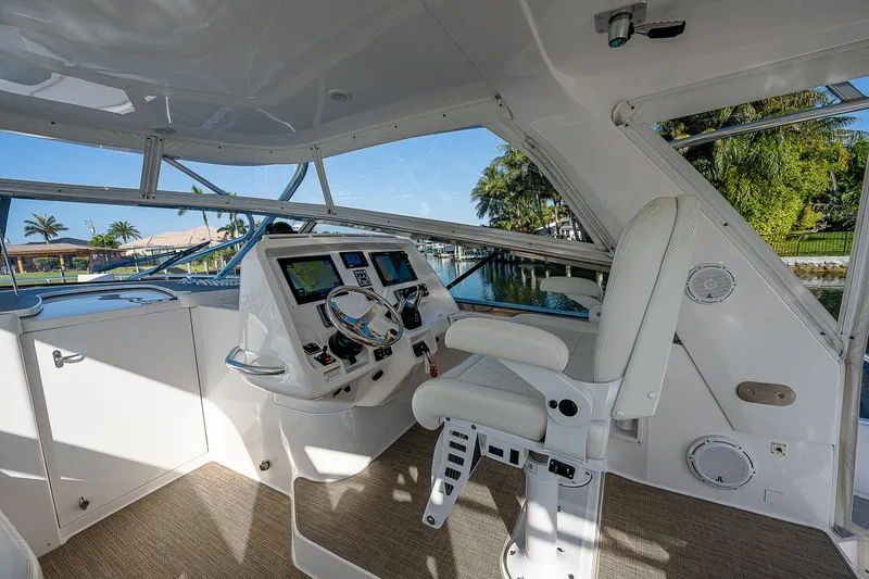 Slide: The Image of Interior helm of 2014 Intrepid 475 Sport Yacht with modern controls and seating. - 20