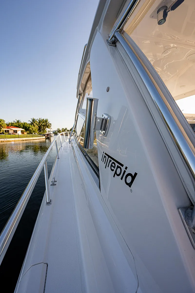 Slide: The Image of Side view of 2014 Intrepid 475 Sport Yacht on calm water. - 22