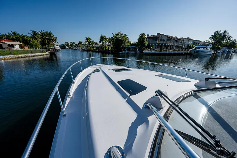 Slide: The Image of Intrepid 475 Sport Yacht 2014 cruising in scenic waterfront area. - 23