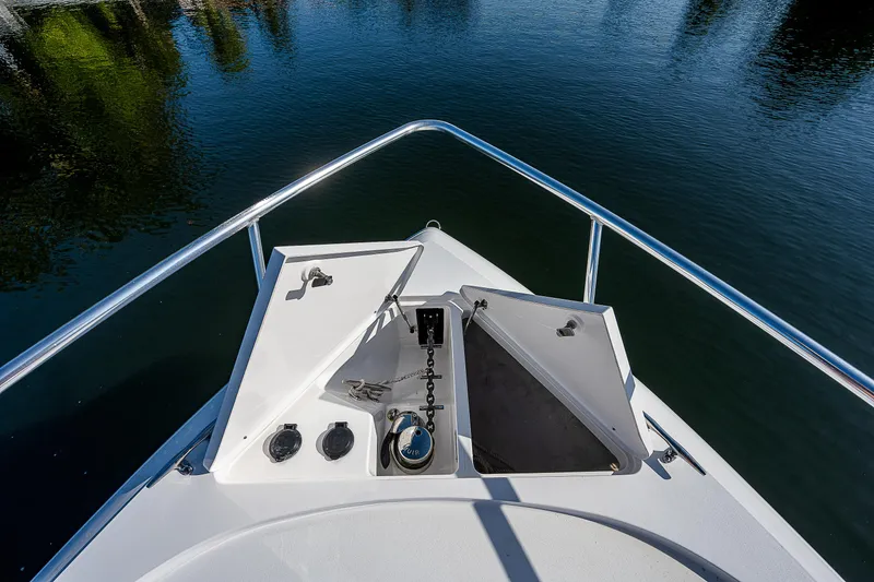 Slide: The Image of Bow view of 2014 Intrepid 475 Sport Yacht on calm water. - 25