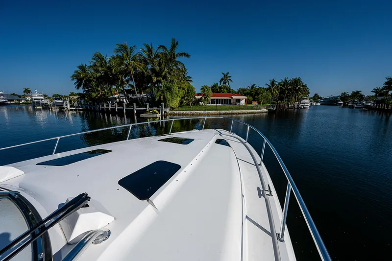 Slide: The Image of Intrepid 475 Sport Yacht 2014 cruising near tropical island with palm trees. - 26