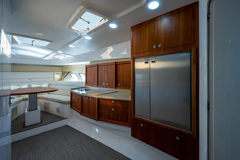 Slide: The Image of Luxurious interior of 2014 Intrepid 475 Sport Yacht with wood cabinetry and modern amenities. - 29