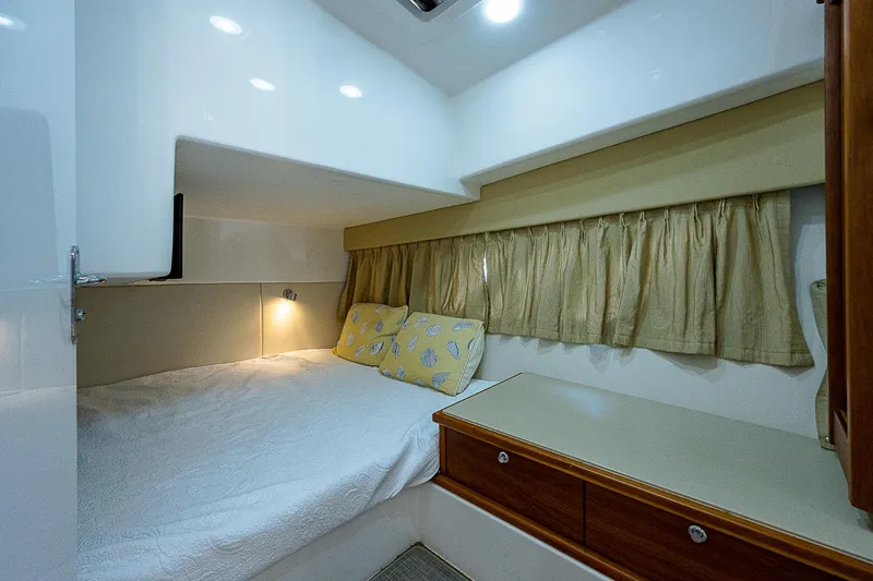 Slide: The Image of Cozy cabin interior of 2014 Intrepid 475 Sport Yacht with bed and storage. - 35