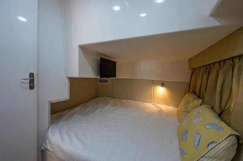 Slide: The Image of Cozy cabin interior of 2014 Intrepid 475 Sport Yacht with bed and soft lighting. - 36